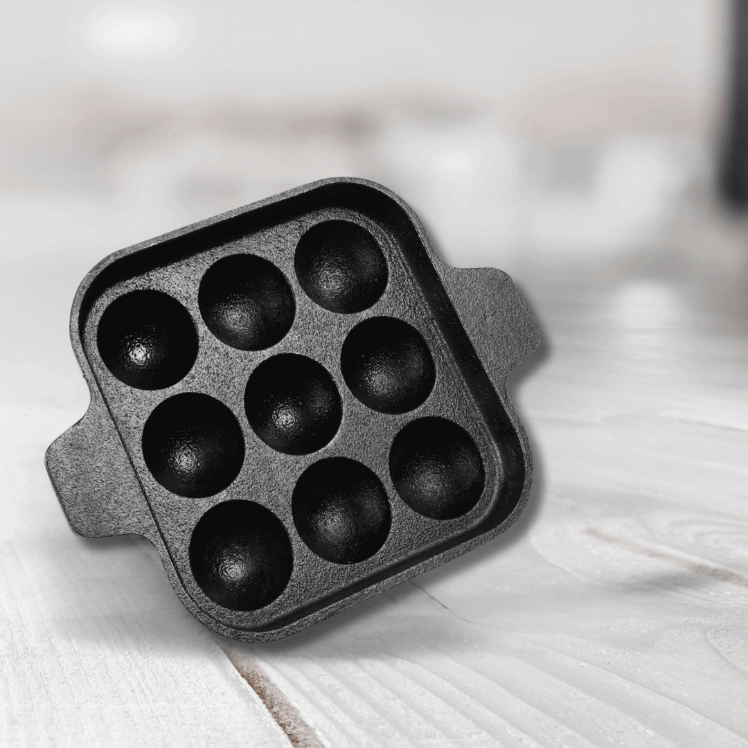Cast Iron 9-Pit Paniyaram Pan with 9 deep pits, perfect for making paniyarams and traditional Indian snacks.