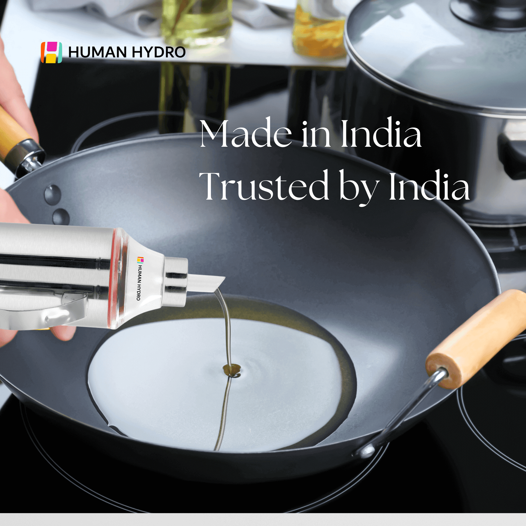 Stainless steel oil dispenser pouring oil into a frying pan, showcasing its drip-free spout and sleek design.