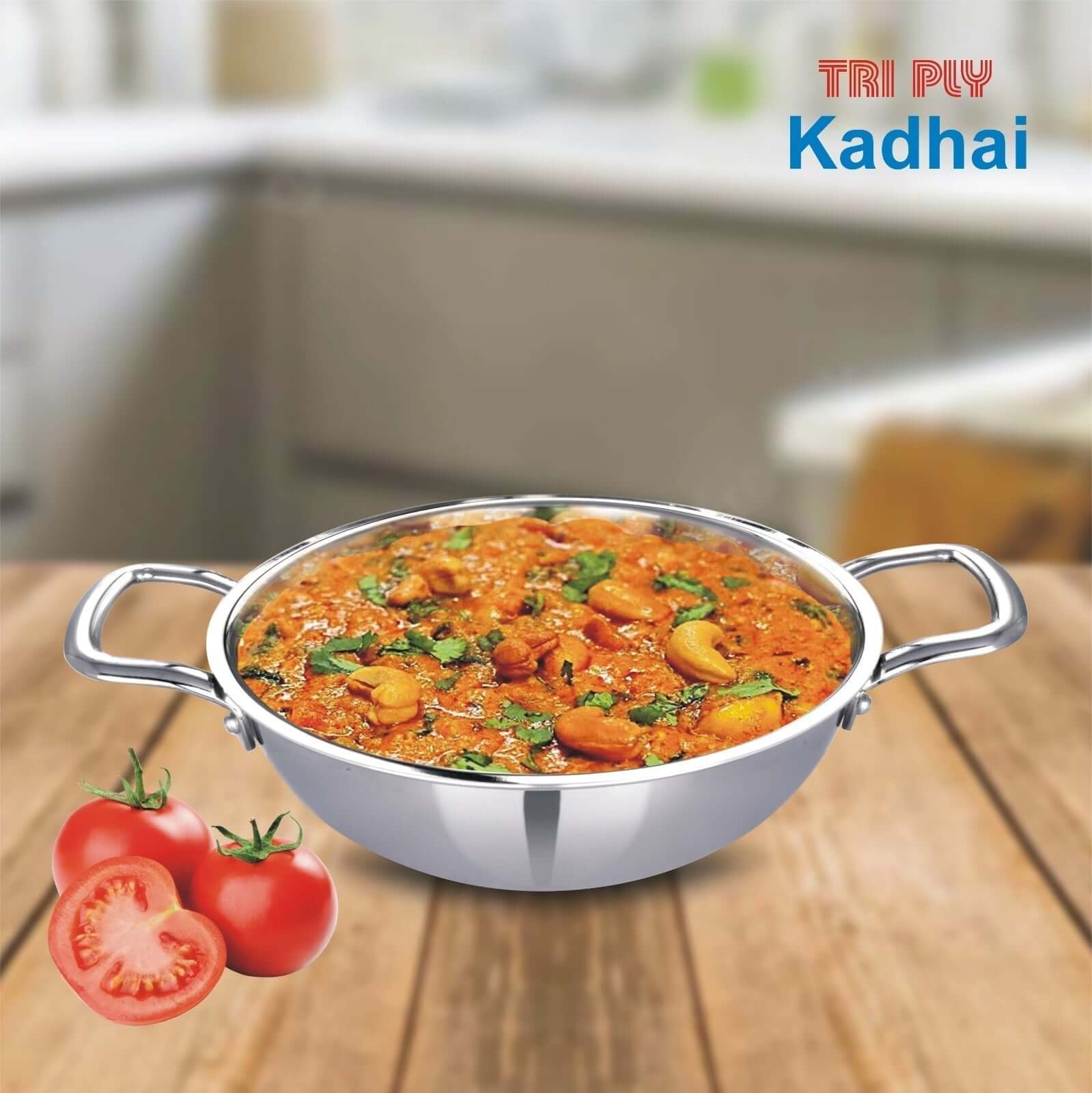 Veg Handi curry in a tri-ply stainless steel kadhai with fresh tomatoes on wooden surface.