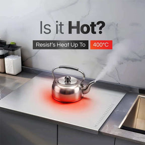 Stainless steel kettle on heat-resistant surface, showcasing steam and temperature resistance up to 400°C.