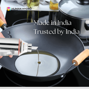 Stainless steel oil dispenser pouring oil into a frying pan, showcasing its drip-free spout and sleek design.
